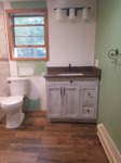 remodeled bathroom with toilet and vanity