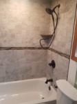 rustic white wash shower tile with listello