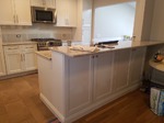 shallow storage cabinets on a 2 tiered kitchen peninsula